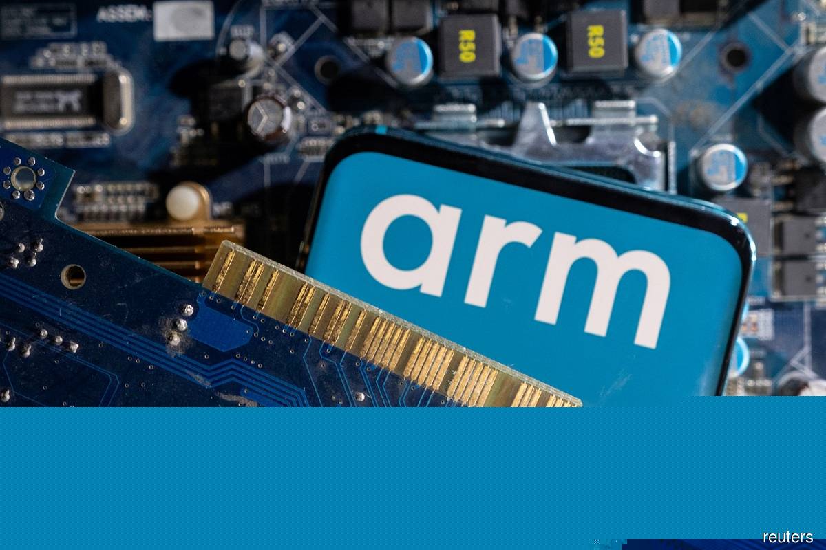 A smartphone with a displayed Arm Ltd logo is placed on a computer motherboard in this illustration taken March 6, 2023. (Reuters pic)